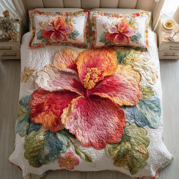 Crimson Hibiscus quilted 3-piece bedding set on a made bed with two matching pillow shams