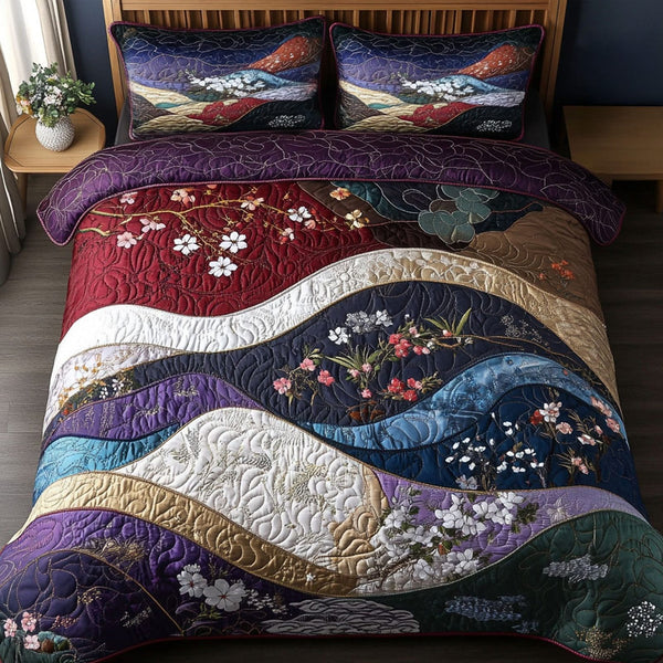 Crimson Mountains quilted 3-piece bedding set on a made bed with two matching pillow shams