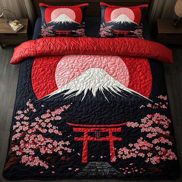Crimson Sunrise quilted 3-piece bedding set on a made bed with two matching pillow shams