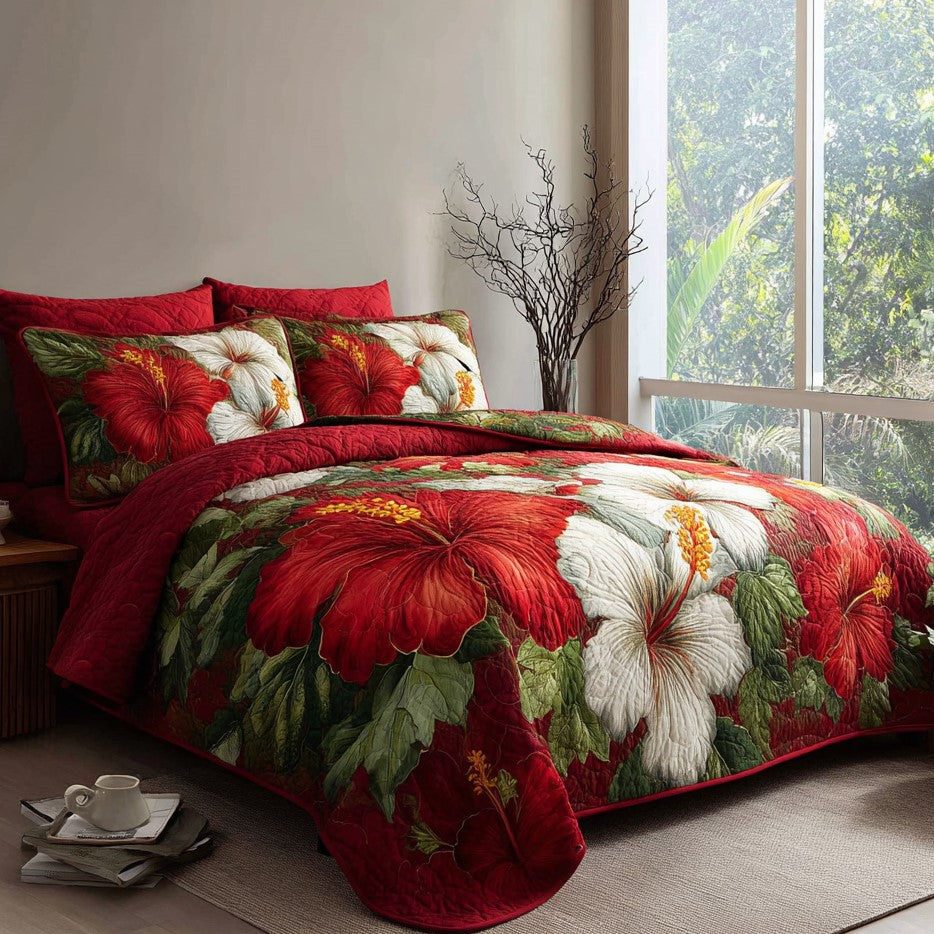 Crimson Tropics quilted 3-piece bedding set on a made bed with two matching pillow shams