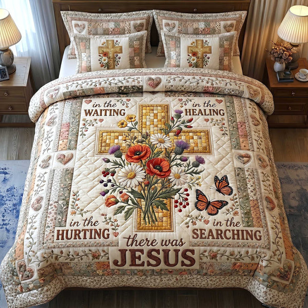 Cross Of Grace quilted 3-piece bedding set on a made bed in a softly lit bedroom
