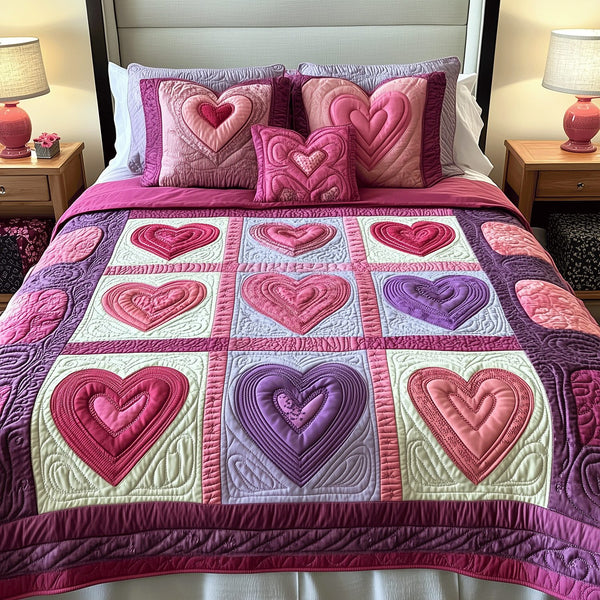 Cuddle Hearts quilted 3-piece bedding set on a made bed with two matching pillow shams