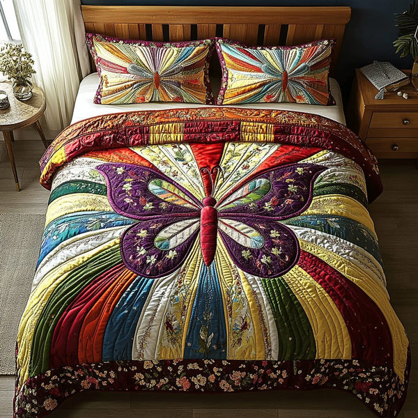 Dancing Wings quilted 3-piece bedding set on a made bed with two matching pillow shams