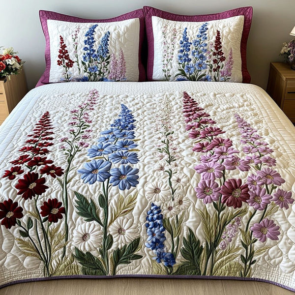Delphinium Melody quilted 3-piece bedding set on a made bed with two matching pillow shams