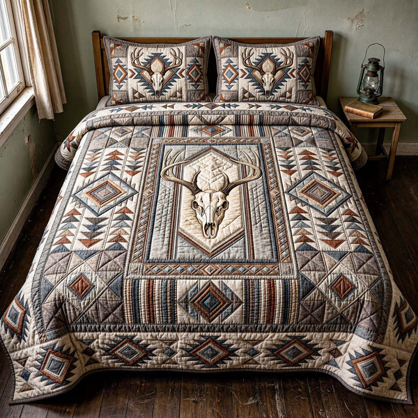 Desert Antlers quilted 3-piece bedding set on a made bed with two matching pillow shams
