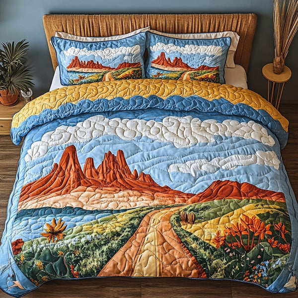Desert Sunset quilted 3-piece bedding set on a made bed with two matching pillow shams