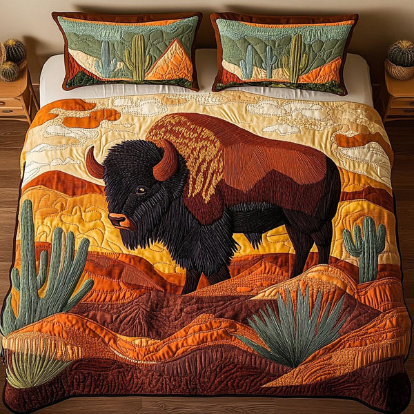 Desert Wanderer quilted 3-piece bedding set on a made bed with two matching pillow shams