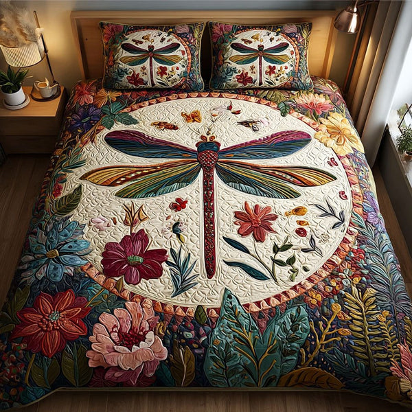 Dragonfly Beauty quilted 3-piece bedding set on a made bed with two matching pillow shams