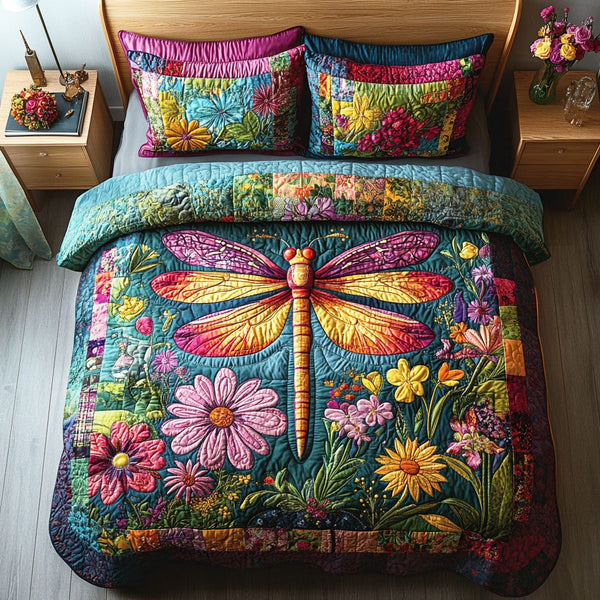 Dragonfly Bloom quilted 3-piece bedding set on a made bed with two matching pillow shams