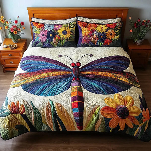 Dragonfly Calm quilted 3-piece bedding set on a made bed with two matching pillow shams