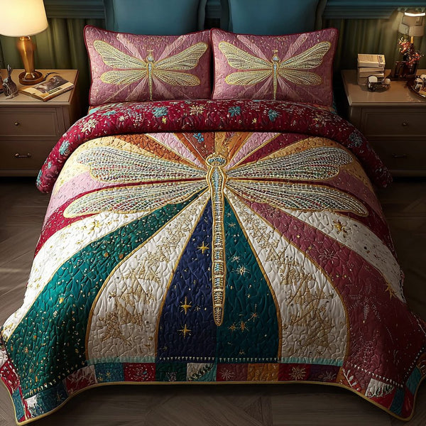 Dragonfly Dance quilted 3-piece bedding set on a made bed with two matching pillow shams