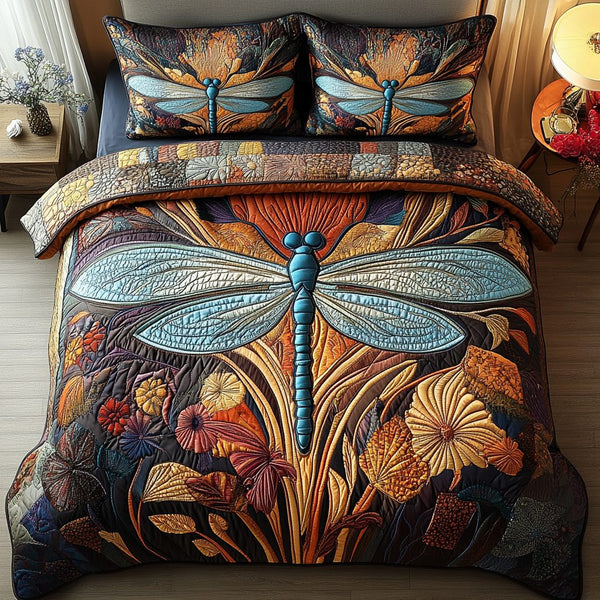 Dragonfly Delight quilted 3-piece bedding set on a made bed with two matching pillow shams