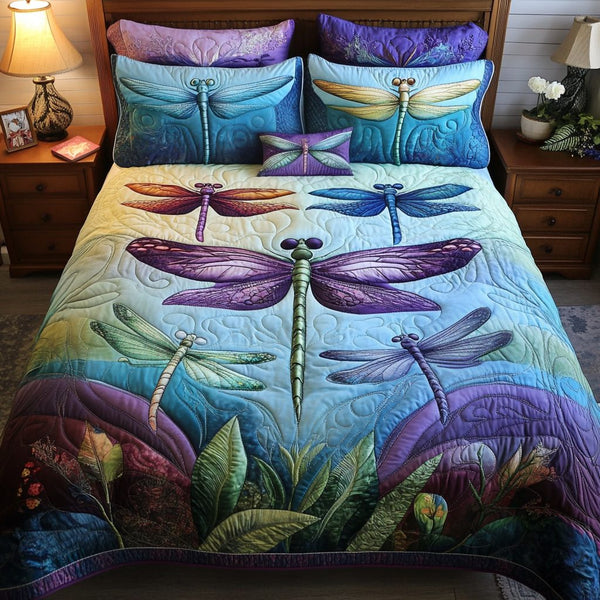 Dragonfly Delight quilted 3-piece bedding set on a made bed with two matching pillow shams