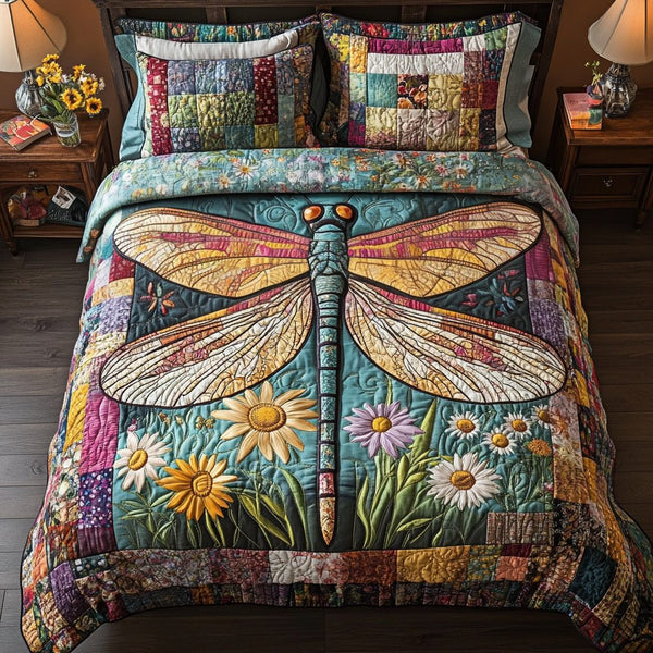 Dragonfly Delight quilted 3-piece bedding set on a made bed with two matching pillow shams