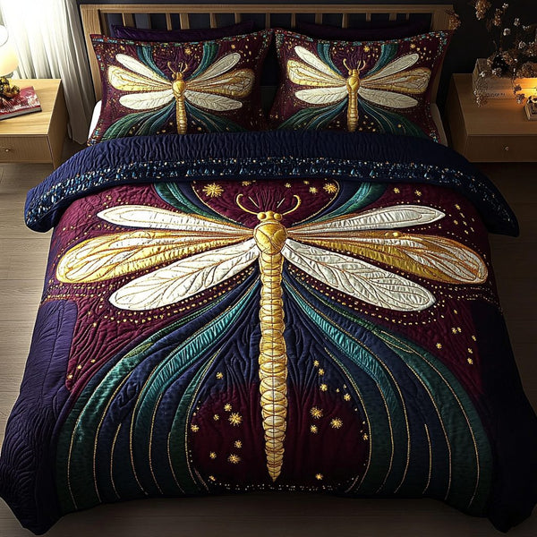 Dragonfly Dreams quilted 3-piece bedding set on a made bed with two matching pillow shams