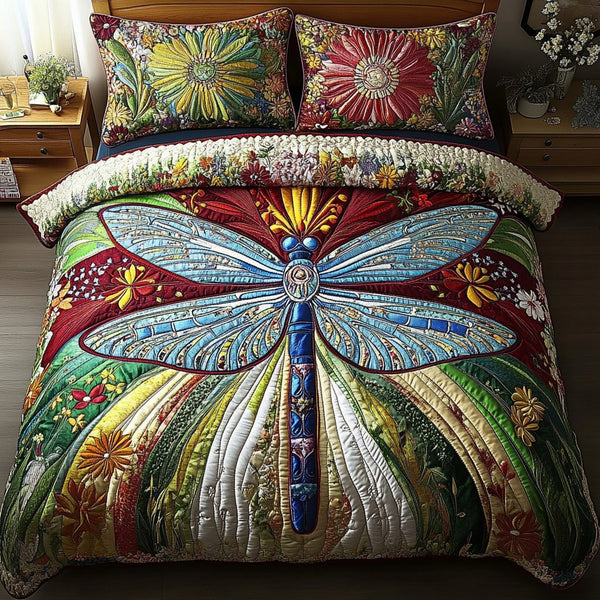 Dragonfly Dreams quilted 3-piece bedding set on a made bed with two matching pillow shams