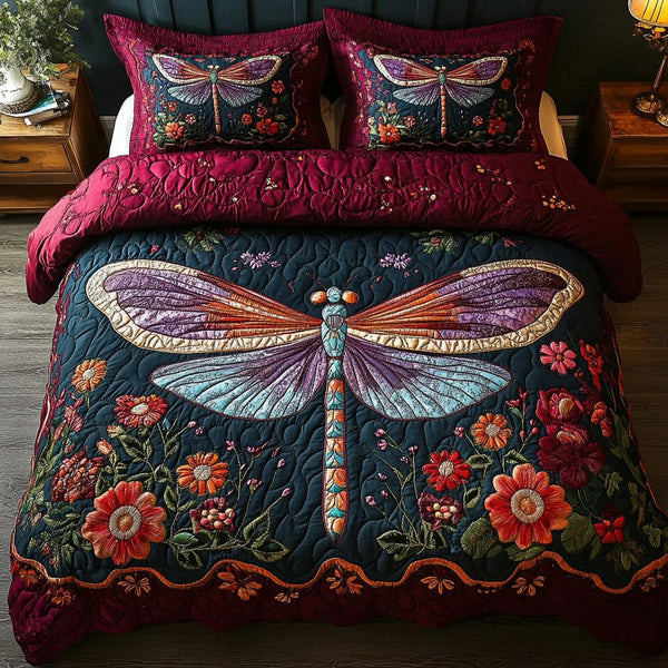 Dragonfly Dreams quilted 3-piece bedding set on a made bed with two matching pillow shams
