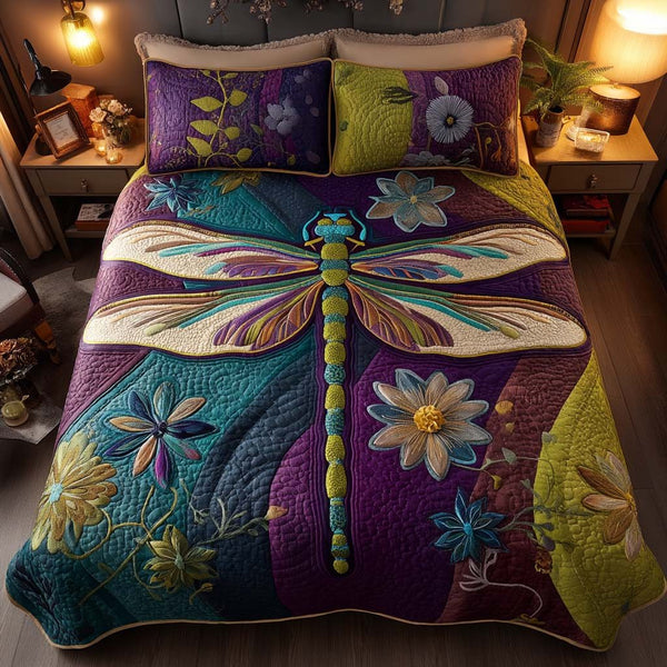 Dragonfly Dreams quilted 3-piece bedding set on a made bed with two matching pillow shams