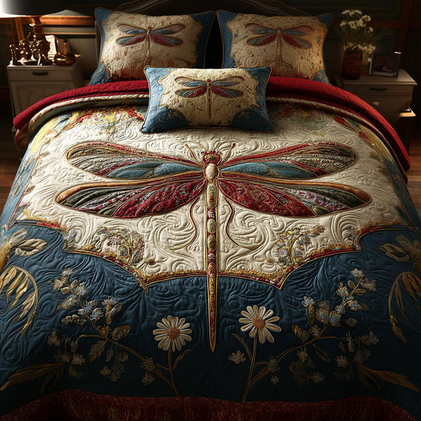 Dragonfly Garden quilted 3-piece bedding set on a made bed with two matching pillow shams