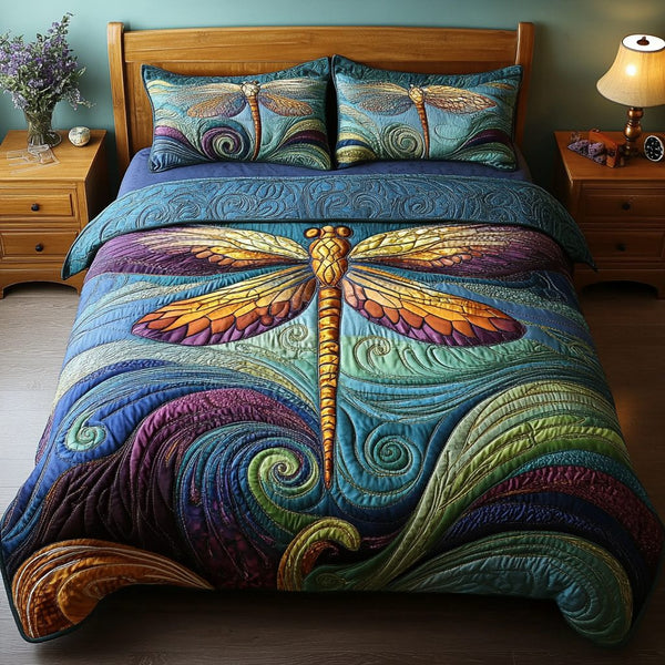 Dragonfly Garden quilted 3-piece bedding set on a made bed with two matching pillow shams