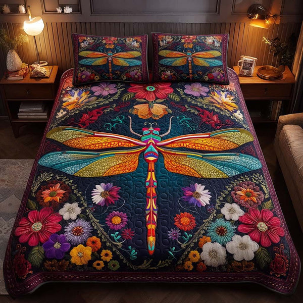 Dragonfly Garden quilted 3-piece bedding set on a made bed with two matching pillow shams