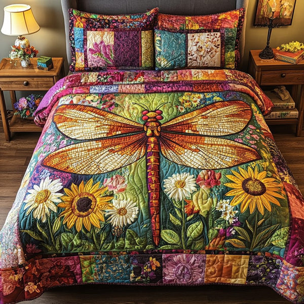 Dragonfly Garden quilted 3-piece bedding set on a made bed with two matching pillow shams
