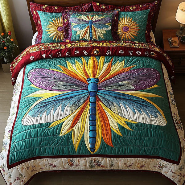 Dragonfly Glimpse quilted 3-piece bedding set on a made bed with two matching pillow shams