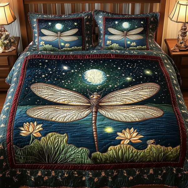 Dragonfly Glow quilted 3-piece bedding set on a made bed with two matching pillow shams