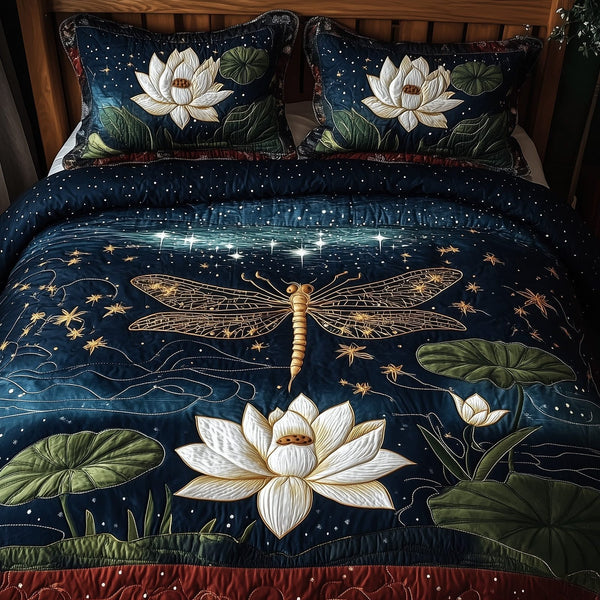 Dragonfly Glow quilted 3-piece bedding set on a made bed with two matching pillow shams
