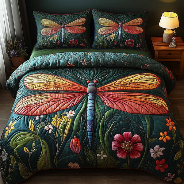 Dragonfly Glow quilted 3-piece bedding set on a made bed with two matching pillow shams