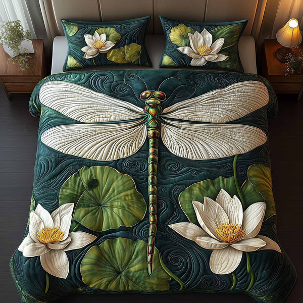 Dragonfly Glow quilted 3-piece bedding set on a made bed with two matching pillow shams