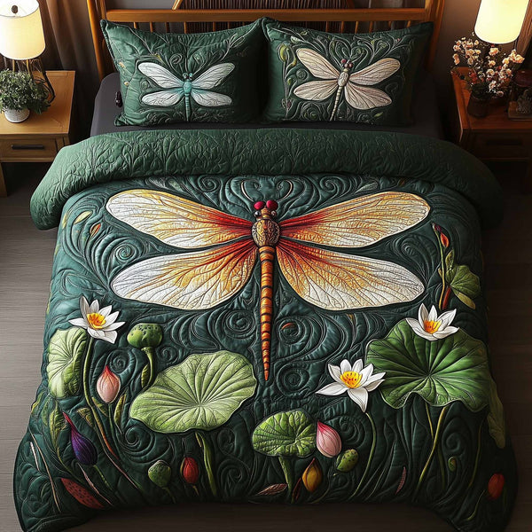 Dragonfly Glow quilted 3-piece bedding set on a made bed with two matching pillow shams