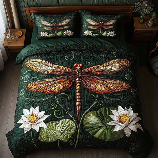 Dragonfly Glow quilted 3-piece bedding set on a made bed with two matching pillow shams