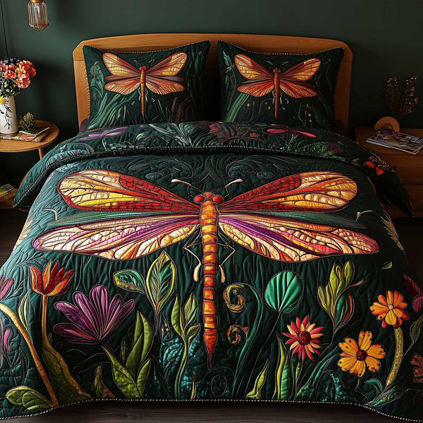 Dragonfly Glow quilted 3-piece bedding set on a made bed with two matching pillow shams