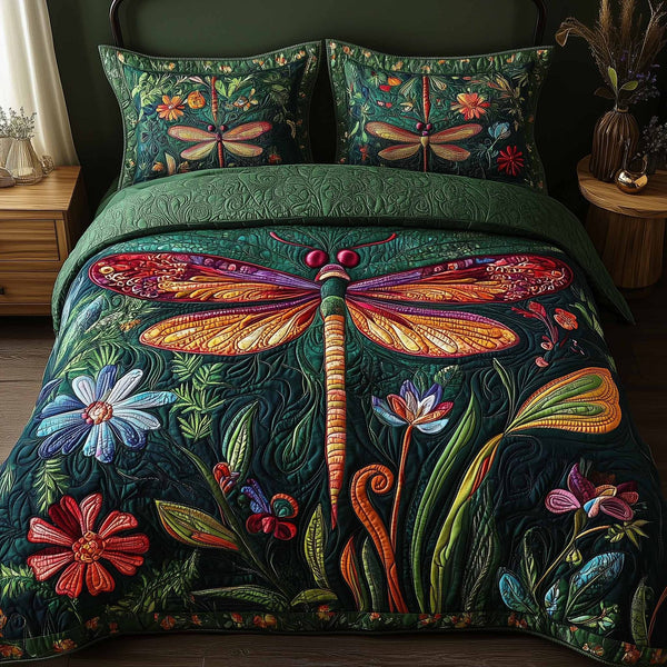 Dragonfly Glow quilted 3-piece bedding set on a made bed with two matching pillow shams