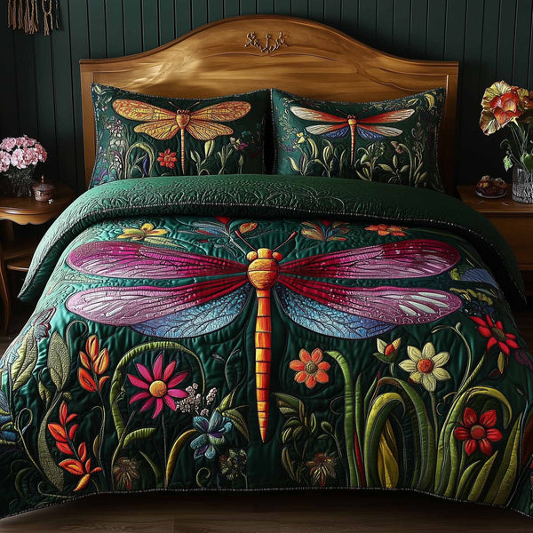 Dragonfly Glow quilted 3-piece bedding set on a made bed with two matching pillow shams