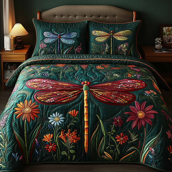 Dragonfly Glow quilted 3-piece bedding set on a made bed with two matching pillow shams