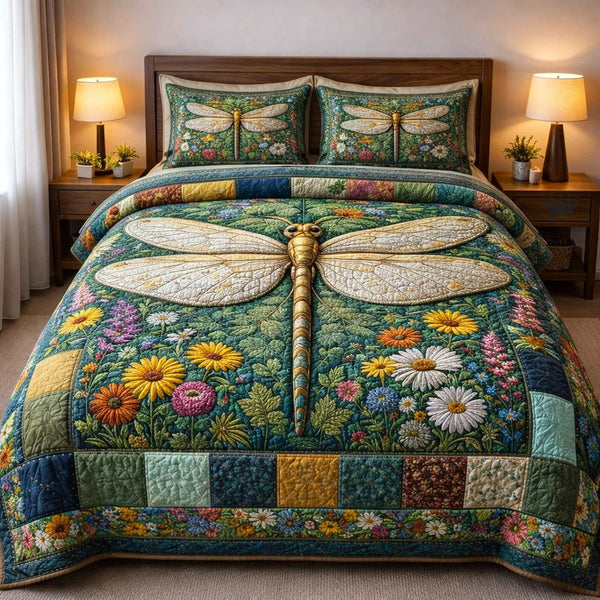 Dragonfly Glow quilted 3-piece bedding set on a made bed with two matching pillow shams