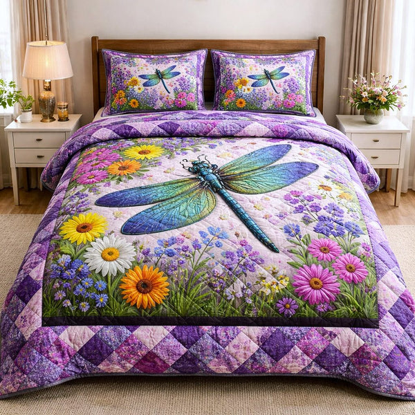 Dragonfly Glow quilted 3-piece bedding set on a made bed with two matching pillow shams