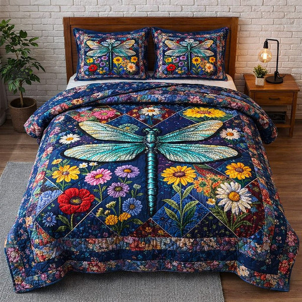 Dragonfly Glow quilted 3-piece bedding set on a made bed with two matching pillow shams