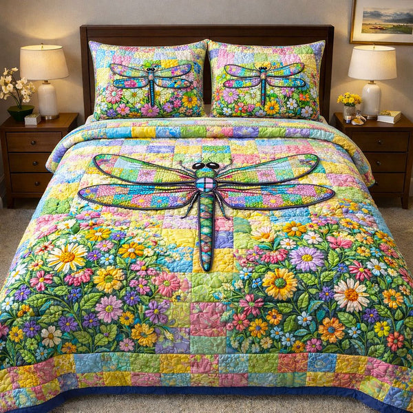 Dragonfly Glow quilted 3-piece bedding set on a made bed with two matching pillow shams