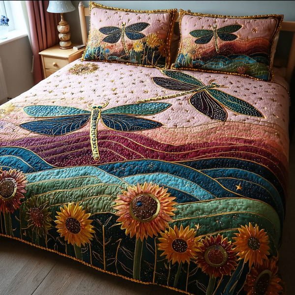 Dragonfly Glow quilted 3-piece bedding set on a made bed with two matching pillow shams