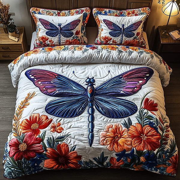 Dragonfly Grace quilted 3-piece bedding set on a made bed with two matching pillow shams