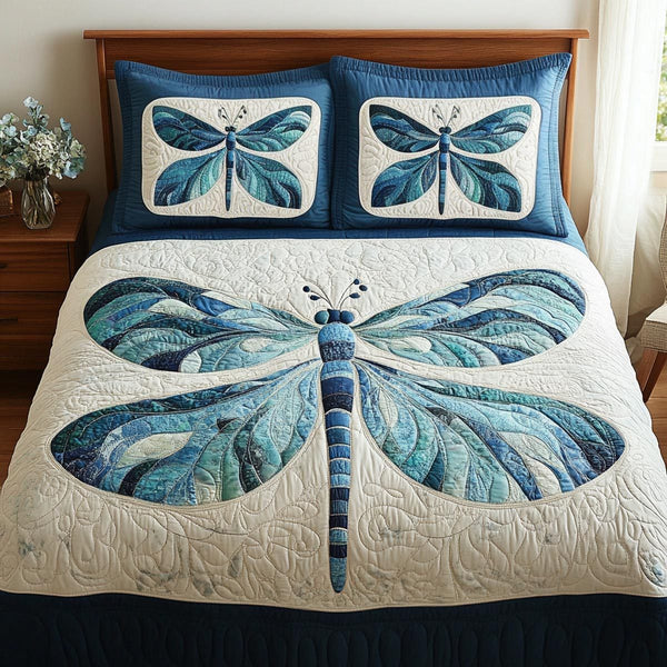 Dragonfly Grace quilted 3-piece bedding set on a made bed with two matching pillow shams