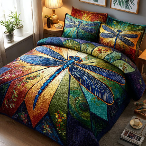 Dragonfly Meadow quilted 3-piece bedding set on a made bed with two matching pillow shams