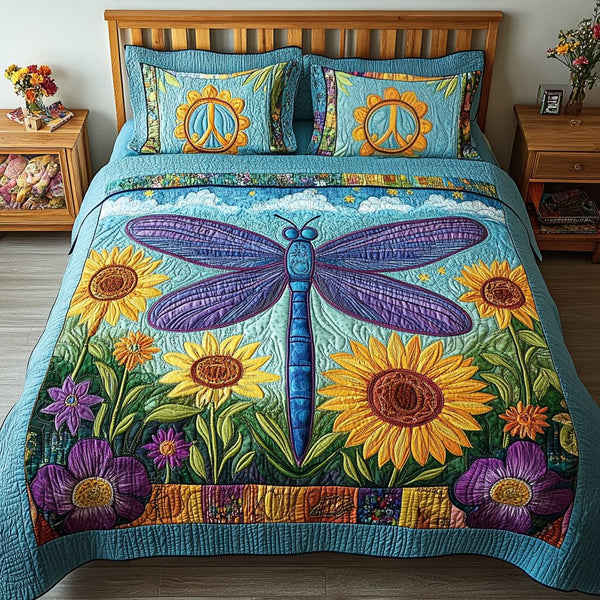 Dragonfly Meadow quilted 3-piece bedding set on a made bed with two matching pillow shams