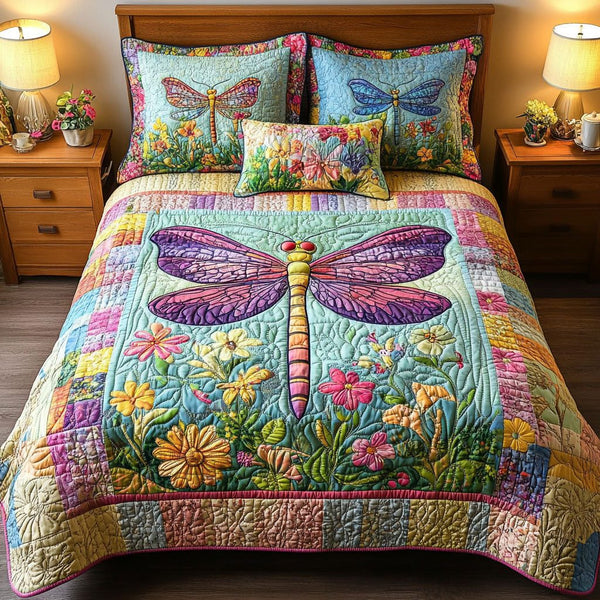 Dragonfly Meadow quilted 3-piece bedding set on a made bed with two matching pillow shams