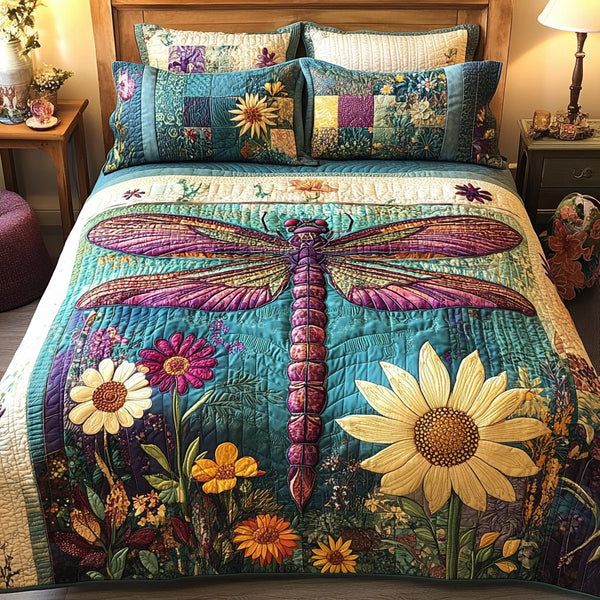 Dragonfly Meadow quilted 3-piece bedding set on a made bed with two matching pillow shams