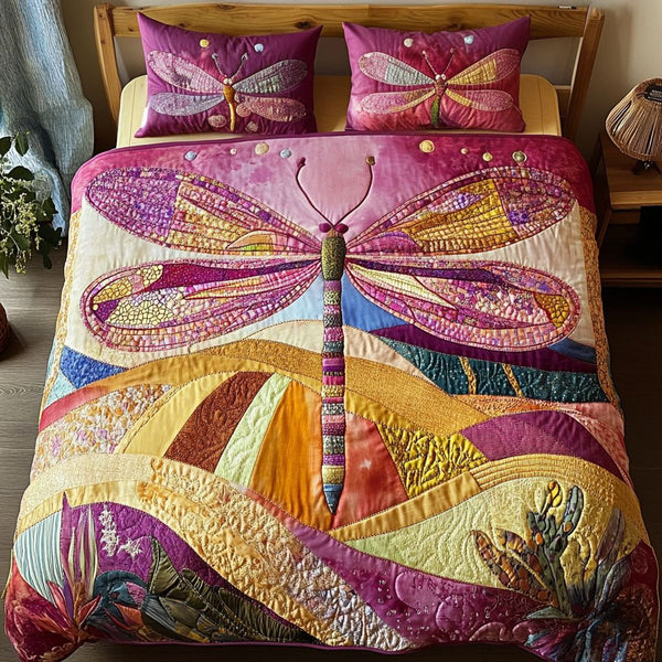 Dragonfly Serenade quilted 3-piece bedding set on a made bed with two matching pillow shams