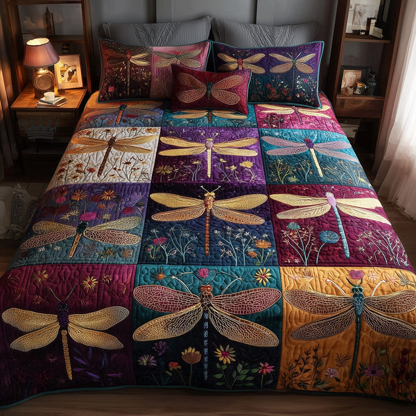 Dragonfly Serenity quilted 3-piece bedding set on a made bed with two matching pillow shams